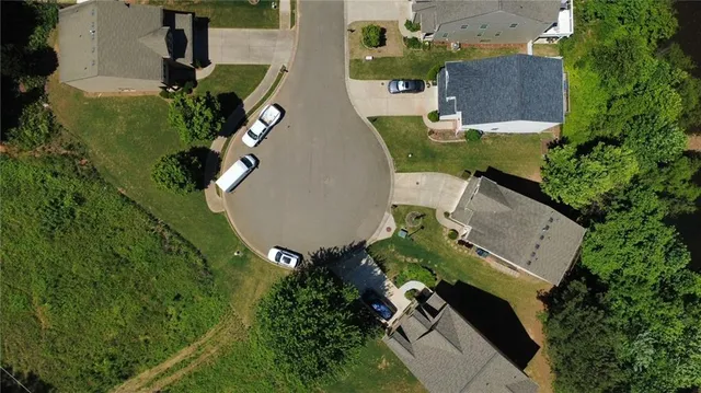 a front view of a house with a yard and potted plants