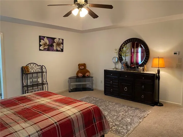 a bed sitting in a bedroom next to a window