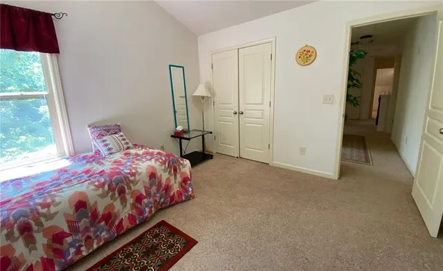 a view of a livingroom with wooden floor and a large window