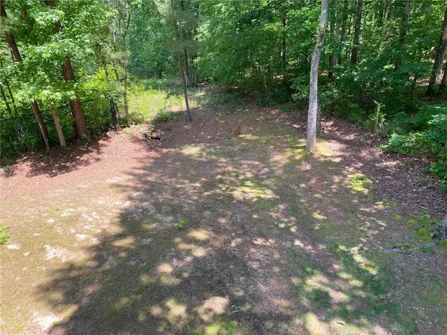 a living room with furniture a chandelier and a flat screen tv