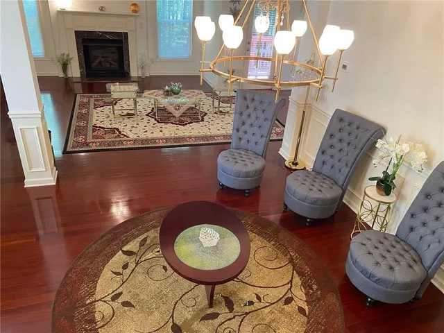 a living room with a rug floor and a fireplace