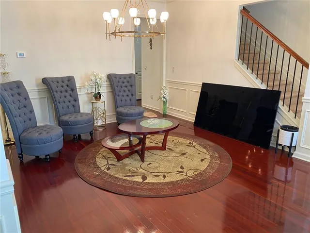 a living room with couches chairs and kitchen view