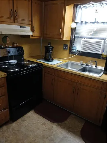 a kitchen with sink and cabinets