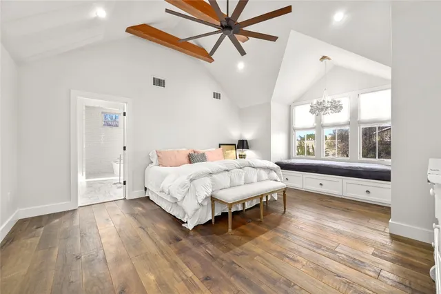 a spacious bathroom with a double vanity sink toilet mirror and bathtub