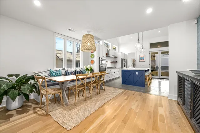 a living room with lots of furniture and a kitchen view