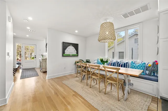 a view of a dining room with furniture and wooden floor