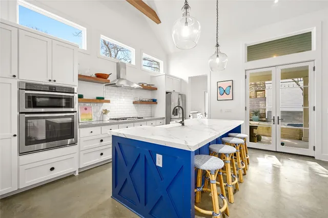 a kitchen with stainless steel appliances kitchen island granite countertop a sink and cabinets