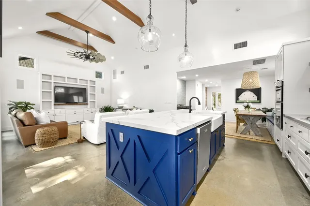 a large kitchen with cabinets a sink and a stove