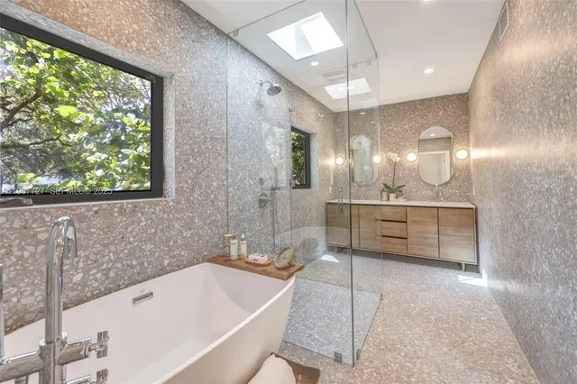 a spacious bedroom with a bed and a chandelier