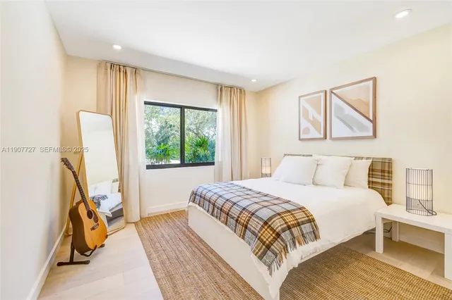 a bed room with a bed and a large window