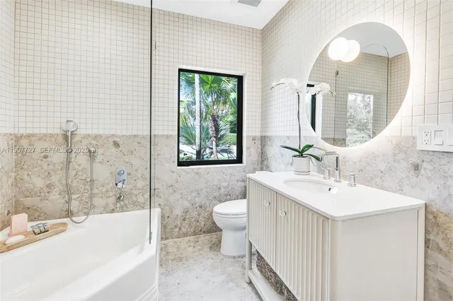 a table and chairs with the view of small garden