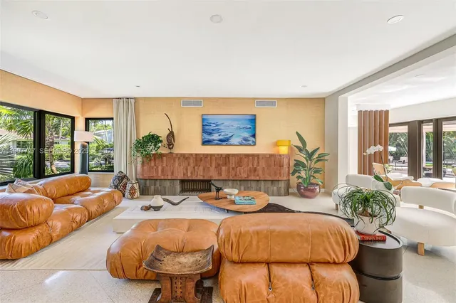 a spacious bedroom with a bed and glass windows
