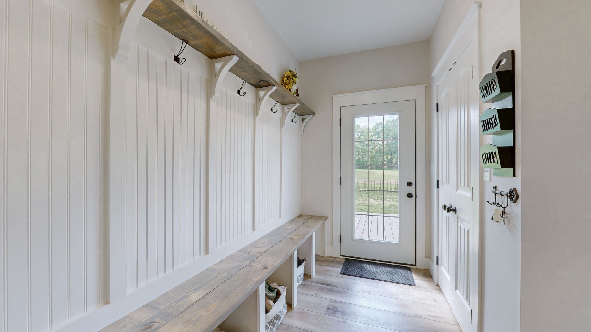 548 Buddy Road Burns, TN 37029 - Photo 15 of 47 a view of a hallway with wooden floor and staircase