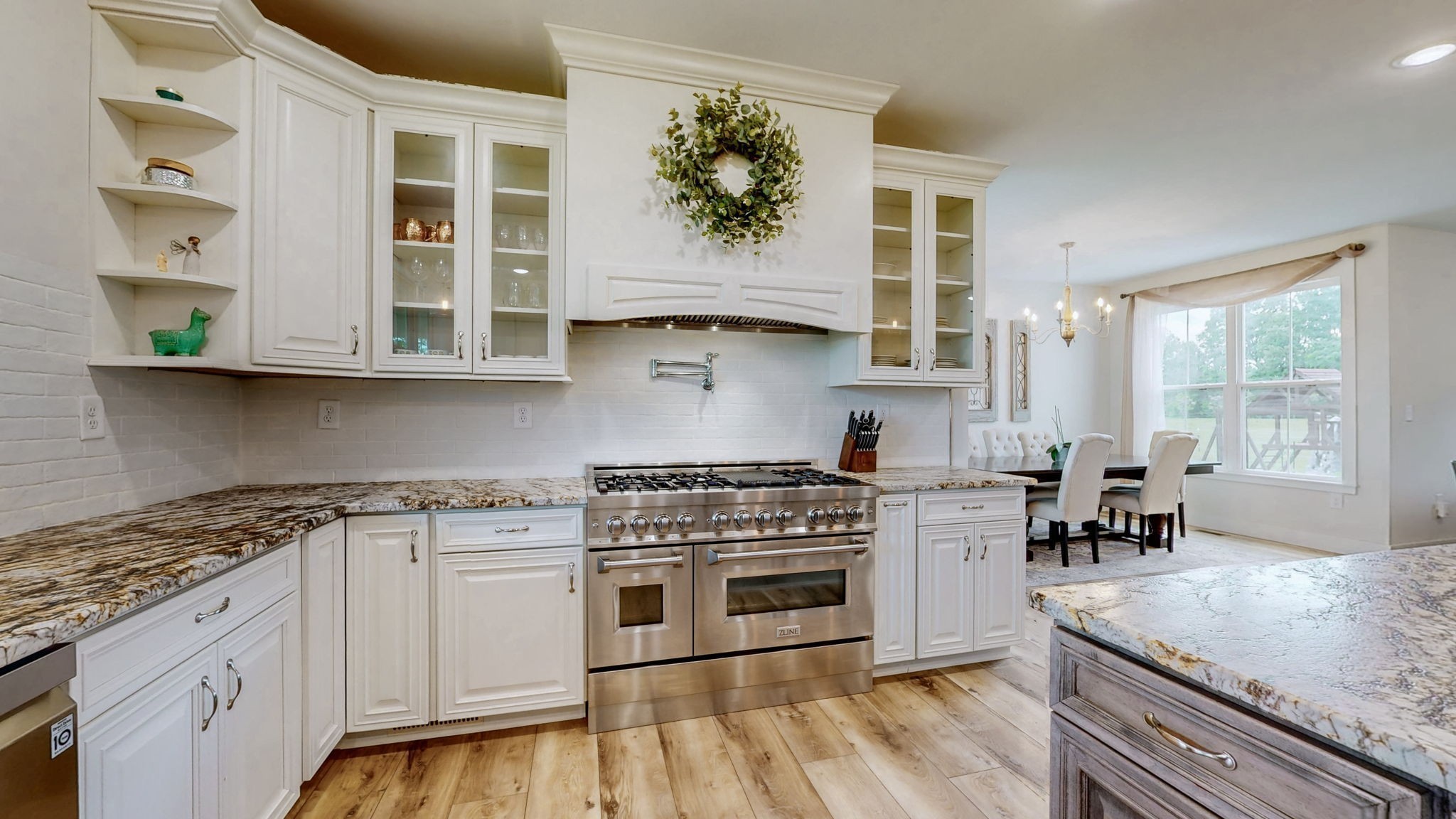 548 Buddy Road Burns, TN 37029 - Photo 7 of 47 a kitchen with stainless steel appliances granite countertop a stove a sink and a microwave