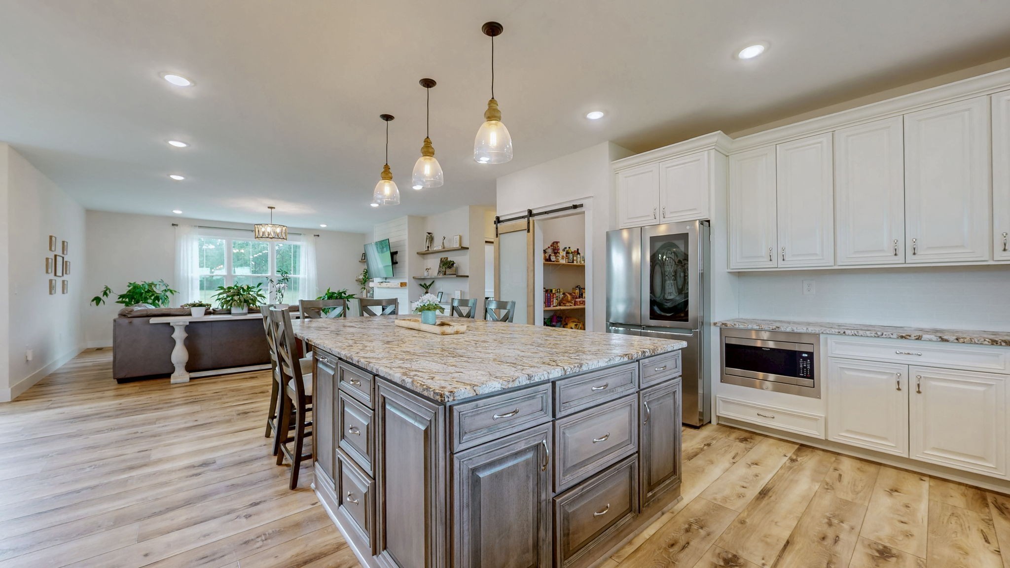 548 Buddy Road Burns, TN 37029 - Photo 8 of 47 a kitchen with kitchen island a stove a refrigerator a sink dishwasher with a dining table and chairs