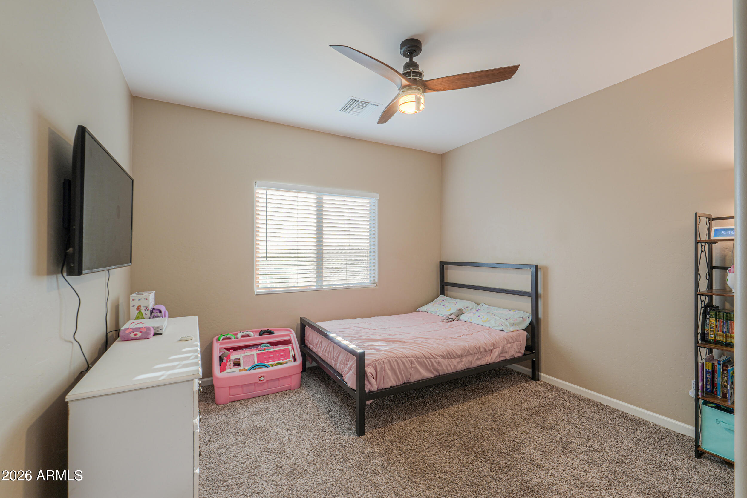 1487 South Mountain View Road Apache Junction, AZ 85119 - Photo 25 of 60 a bedroom with a bed and a flat screen tv