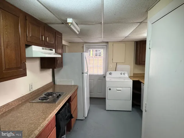 a kitchen with a stove a sink and a refrigerator