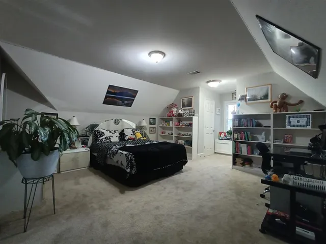 a living room with furniture and a book shelf