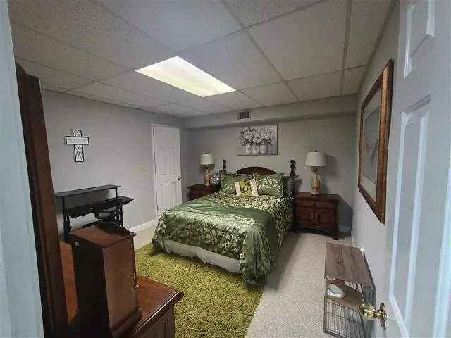 a bedroom with bed and a window