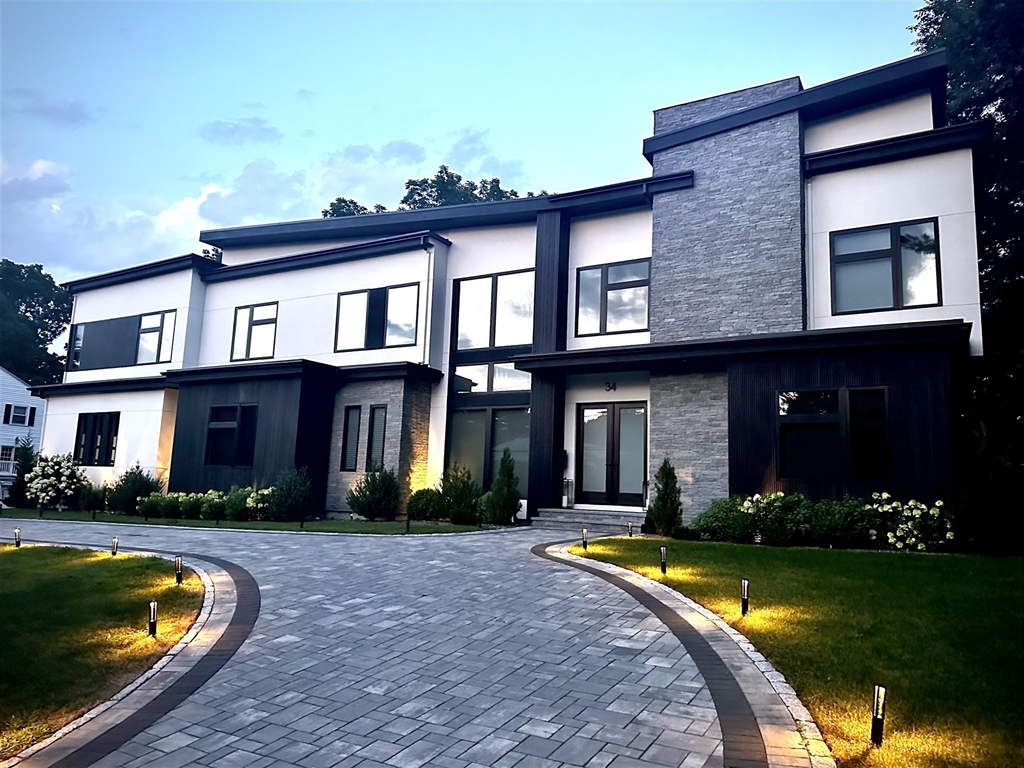 a front view of a house with swimming pool and yard