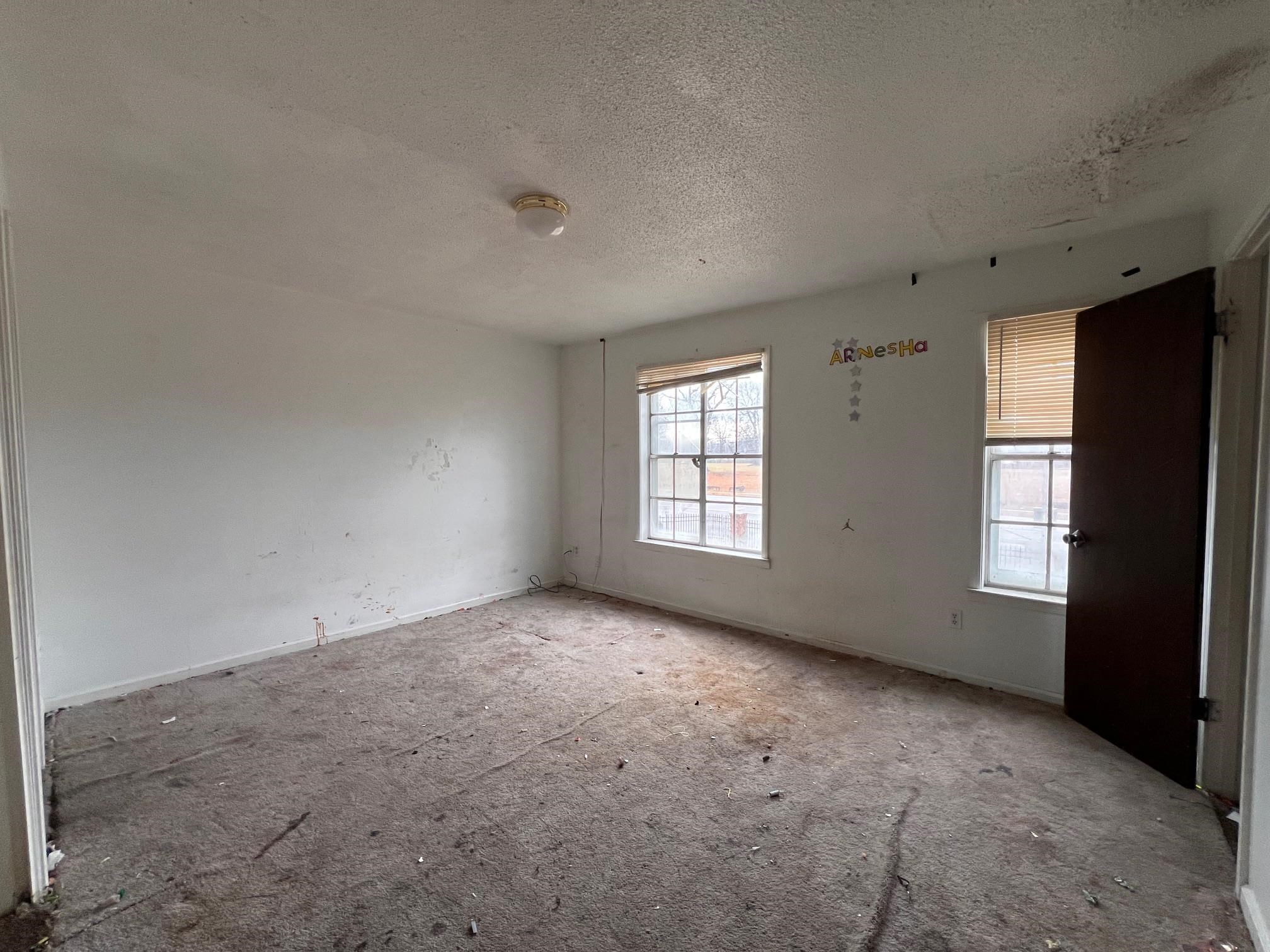 4783 Winchester Road Memphis, TN 38118 - Photo 11 of 14 Spare room featuring baseboards and a textured ceiling