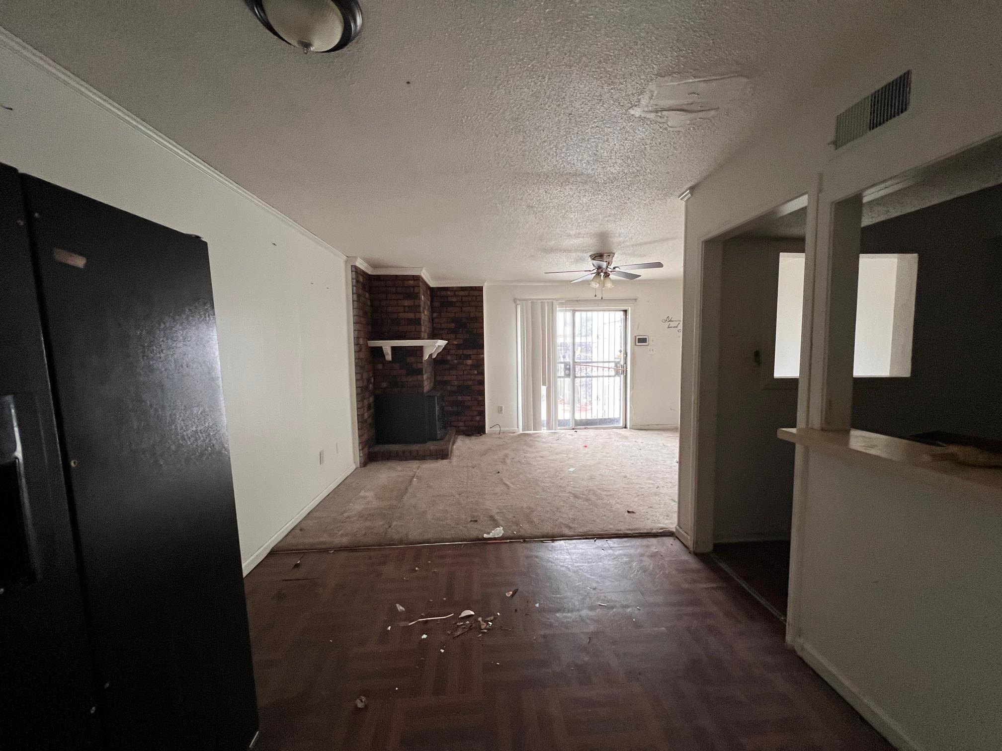 4783 Winchester Road Memphis, TN 38118 - Photo 7 of 14 Unfurnished living room featuring parquet flooring, a textured ceiling, and ceiling fan