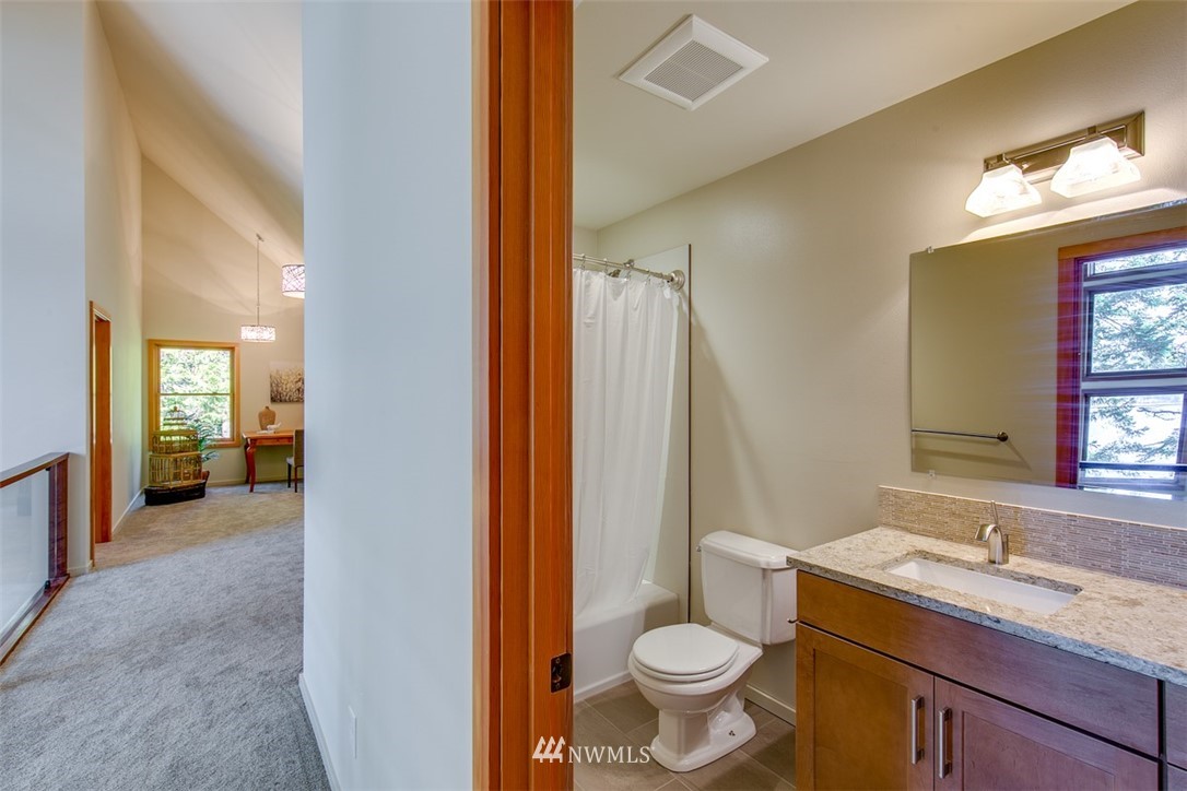 831 Griffith Point Road Nordland, WA 98358 - Photo 22 of 25 a bathroom with a granite countertop sink toilet and shower