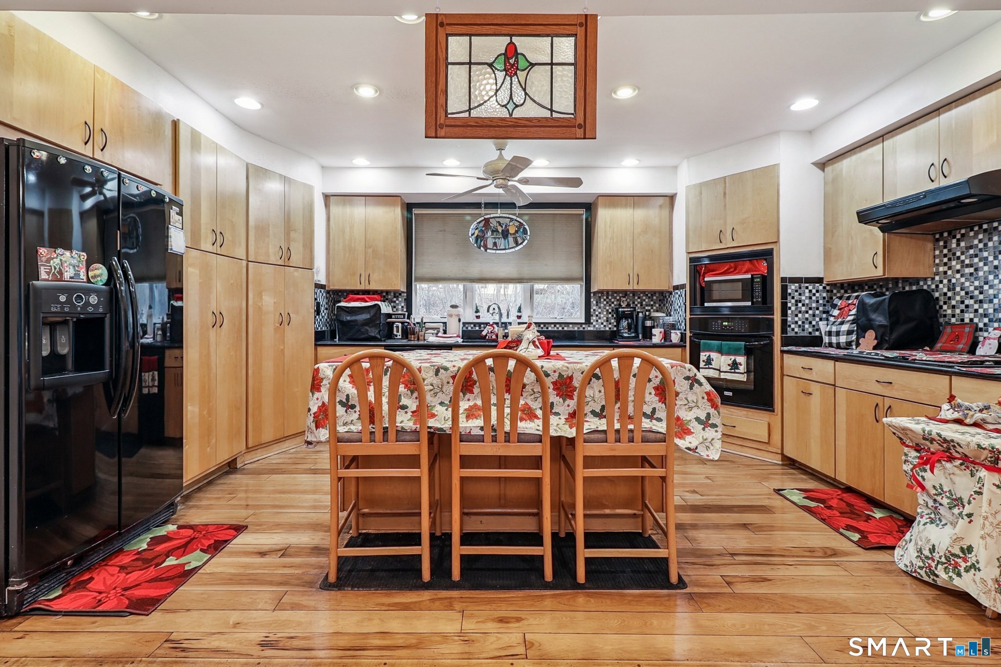 36 Spinning Wheel Road Monroe, CT 06468 - Photo 16 of 25 a kitchen with stainless steel appliances kitchen island granite countertop a table and chairs