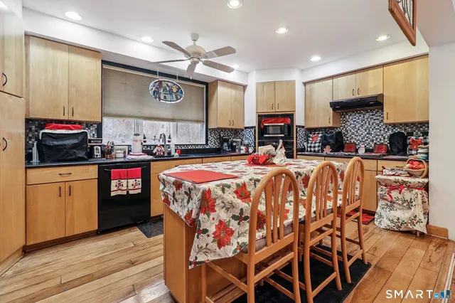 a kitchen with stainless steel appliances granite countertop a sink and cabinets