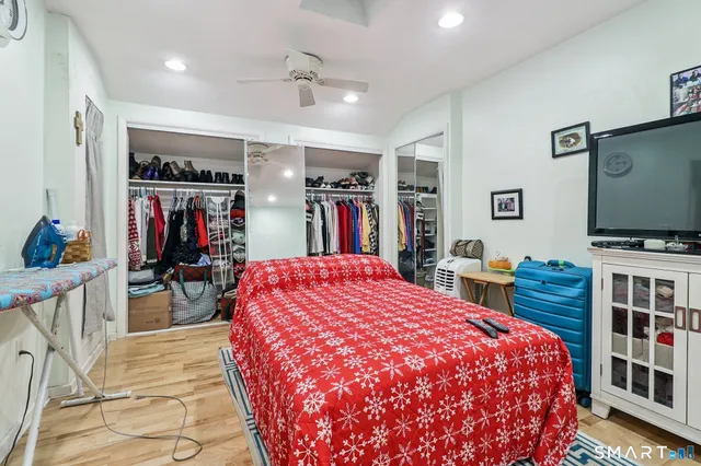 a bed room with a bed and a flat screen tv