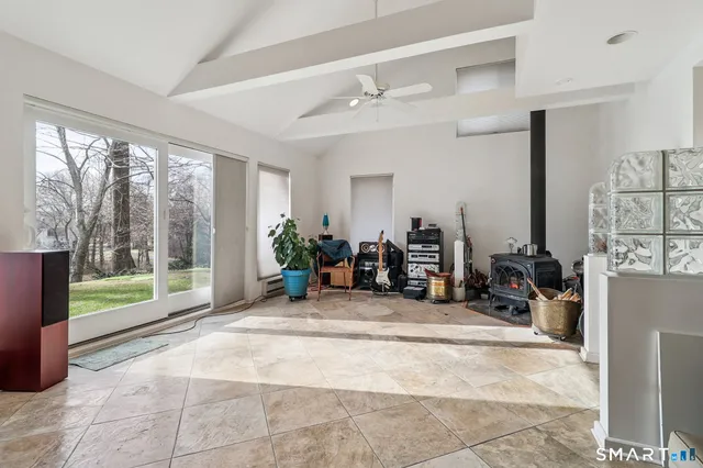 a view of a room with gym equipment and floor to ceiling window