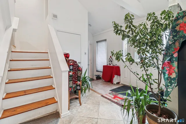 a vase of flowers sitting on a floor