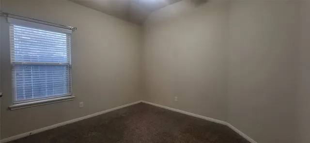 a view of a house with a small yard and wooden fence