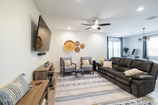 a living room with furniture ceiling fan and a rug