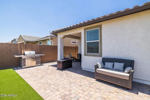 a view of a backyard with chairs