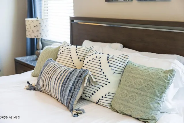 a bedroom with a bed and a mirror