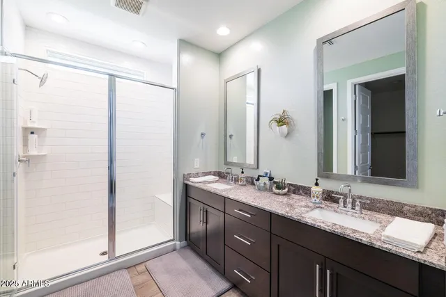 a bathroom with a granite countertop sink mirror and double