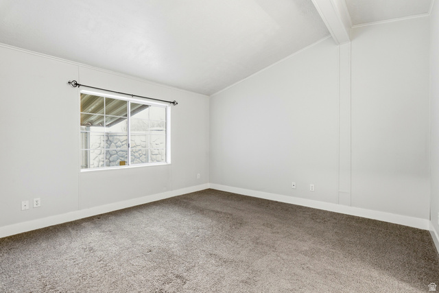150 West 7500th South, Unit 55 Midvale, UT 84047 - Photo 22 of 28 Empty room featuring carpet flooring, lofted ceiling with beams, and ornamental molding