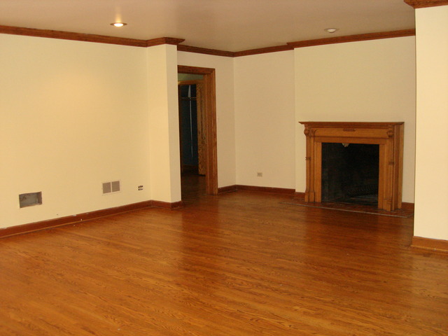 149 Algonquin Road Zion, IL 60099 - Photo 13 of 25 a view of an empty room with wooden floor and a window