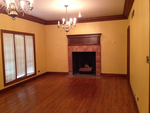 149 Algonquin Road Zion, IL 60099 - Photo 5 of 25 a view of an empty room with wooden floor fireplace and a window