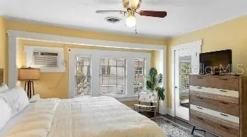 a bedroom with a bed and large mirror