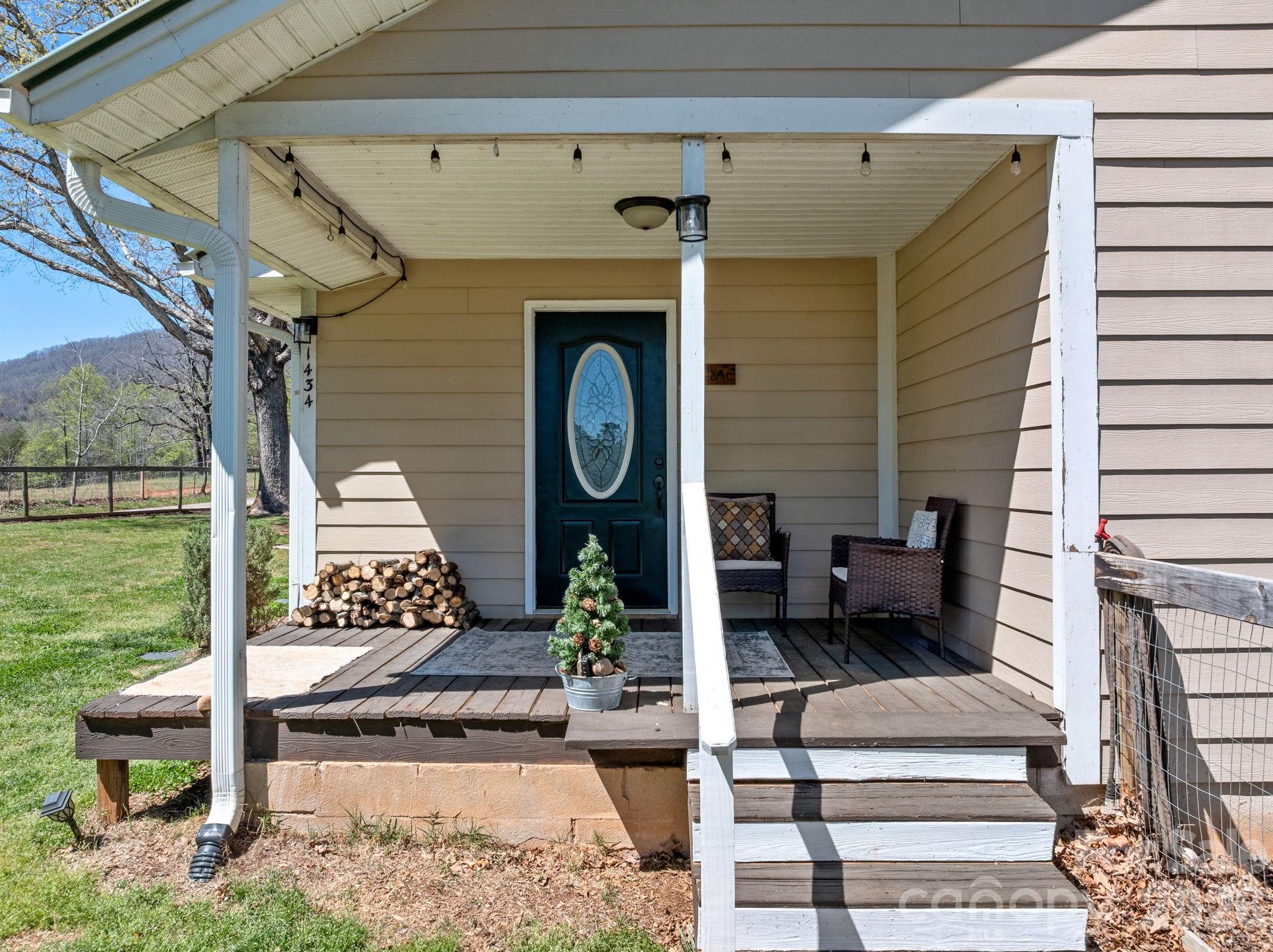 1434 Lake Adger Road Mill Spring, NC 28756 - Photo 1 of 47 a front view of a house with garden