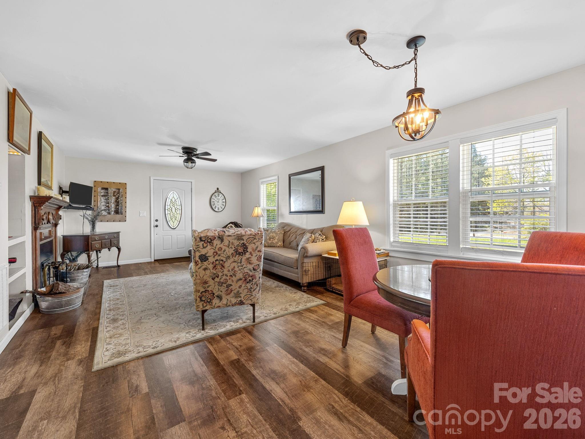 1434 Lake Adger Road Mill Spring, NC 28756 - Photo 11 of 47 a living room with furniture chandelier and a window