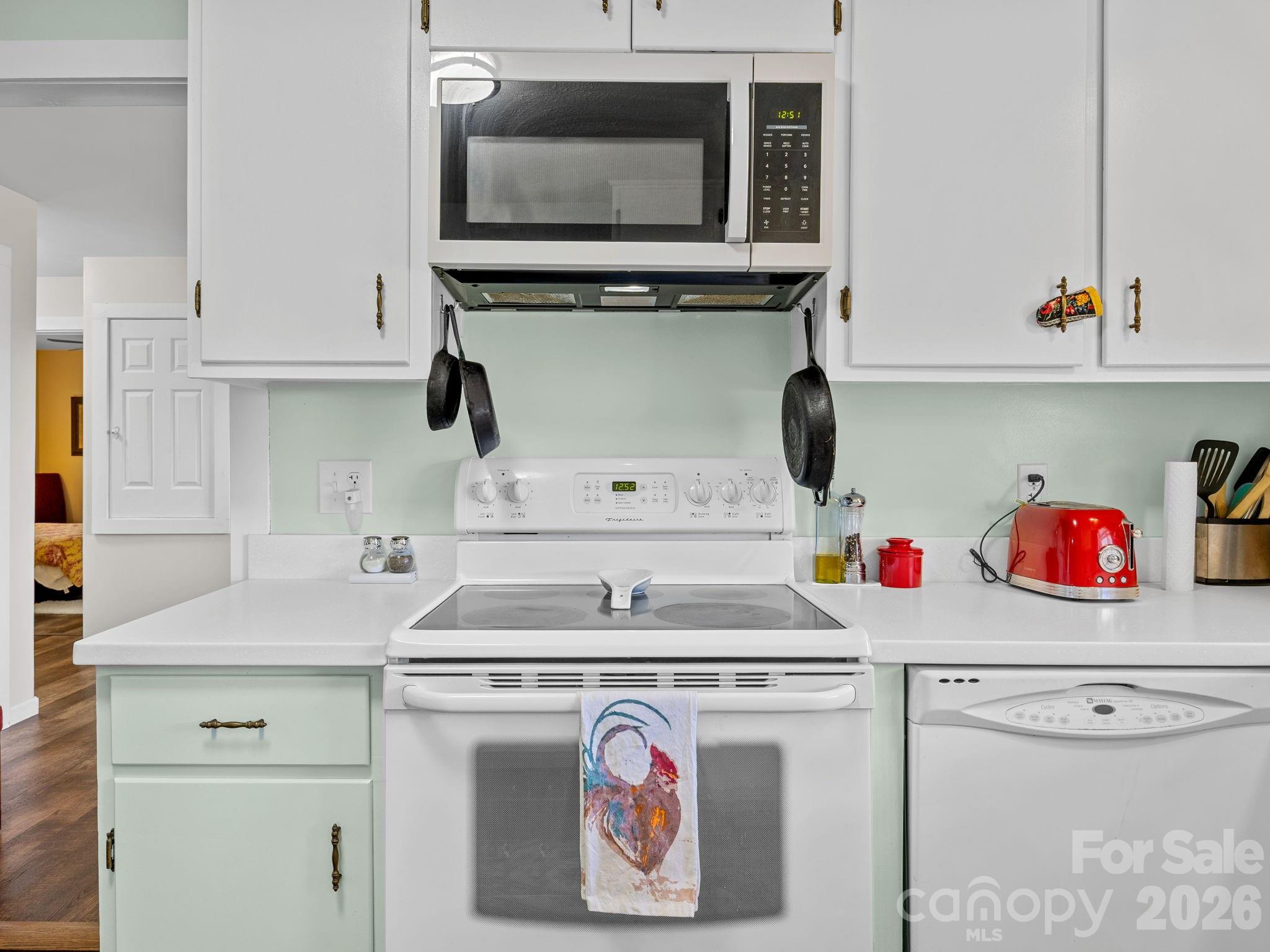 1434 Lake Adger Road Mill Spring, NC 28756 - Photo 14 of 47 a utility room with a stove and cabinets
