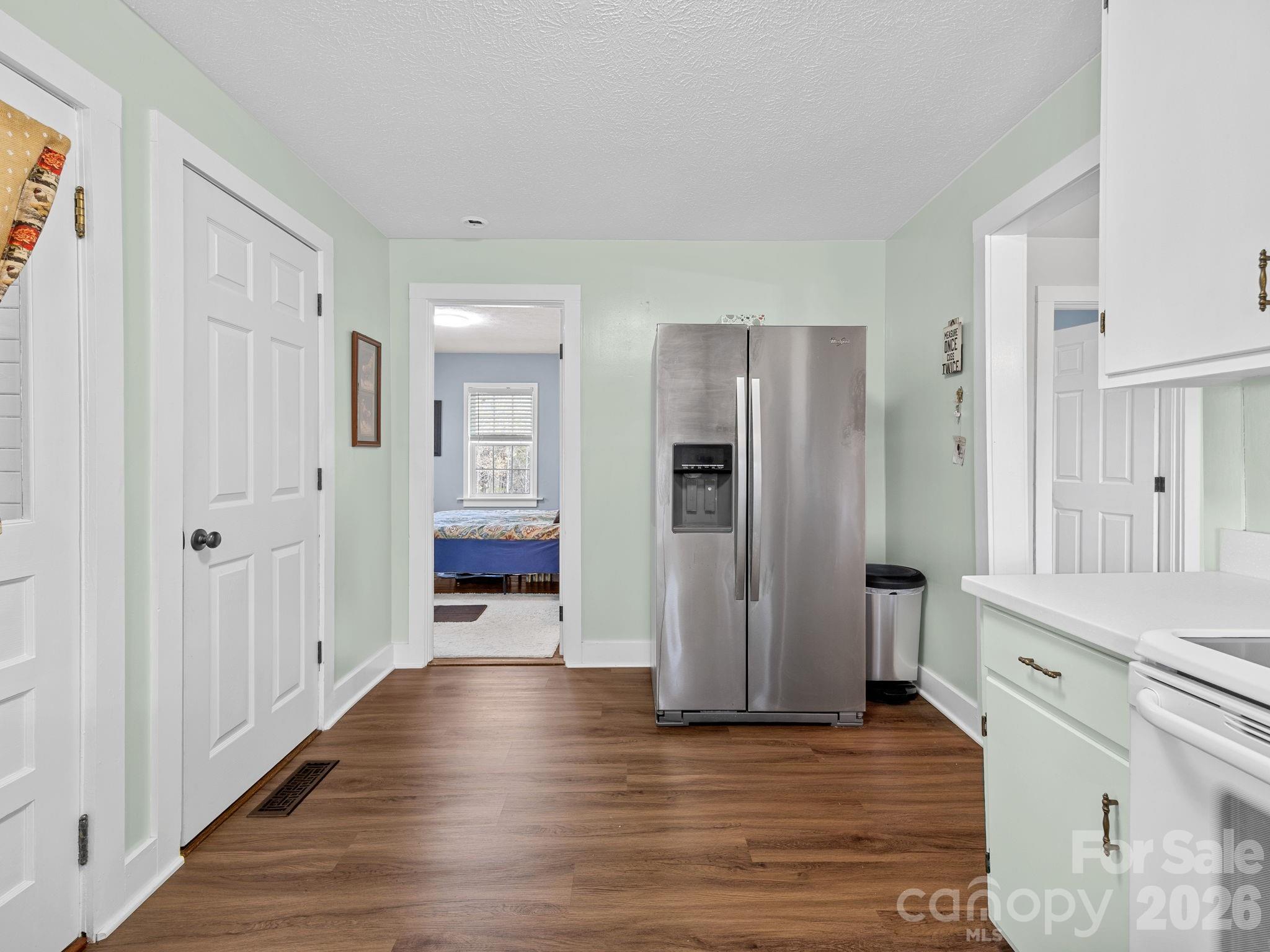 1434 Lake Adger Road Mill Spring, NC 28756 - Photo 15 of 47 a view of a hallway with wooden floor windows and a living room