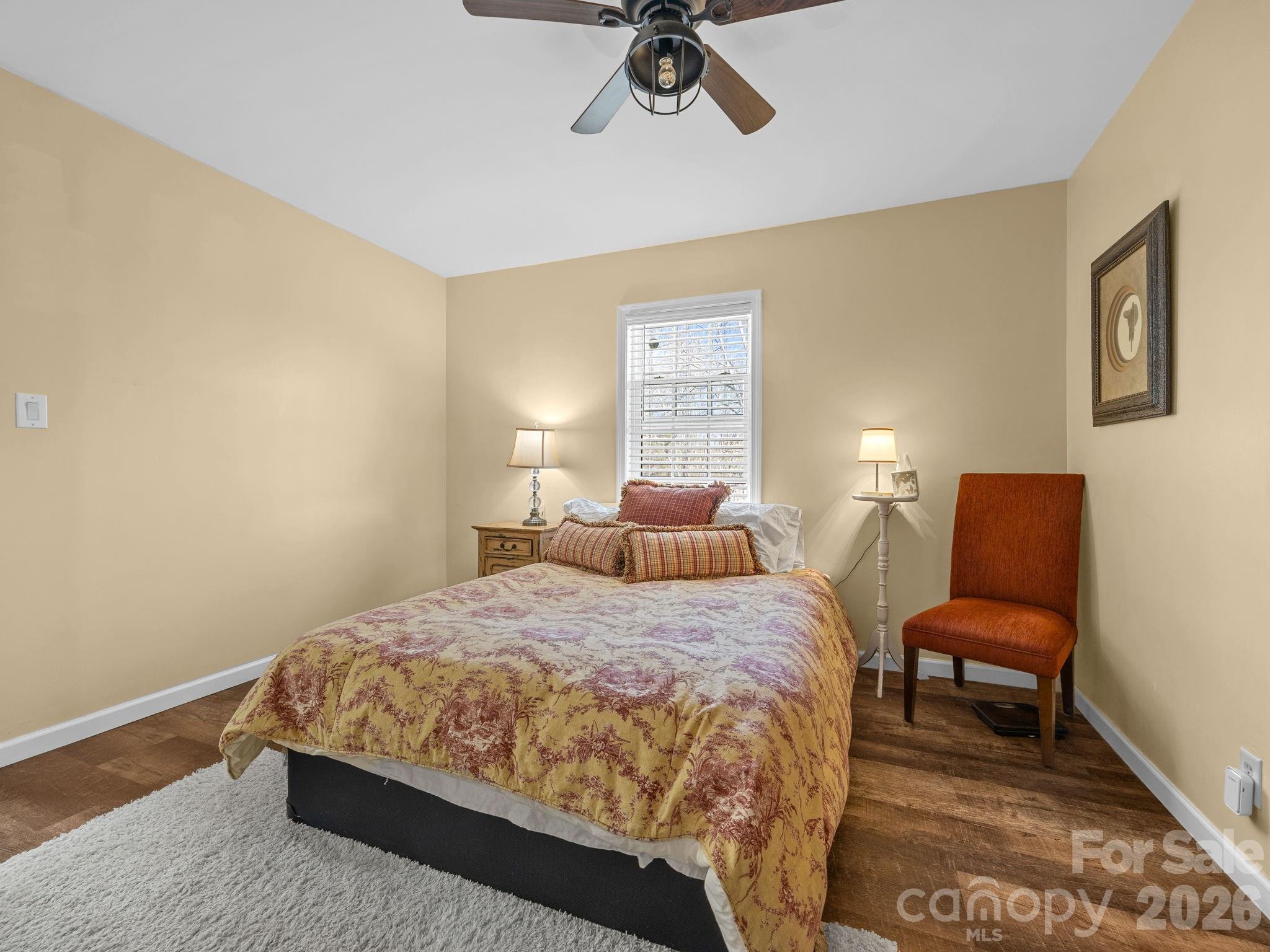 1434 Lake Adger Road Mill Spring, NC 28756 - Photo 17 of 47 a bedroom with a bed and a chair