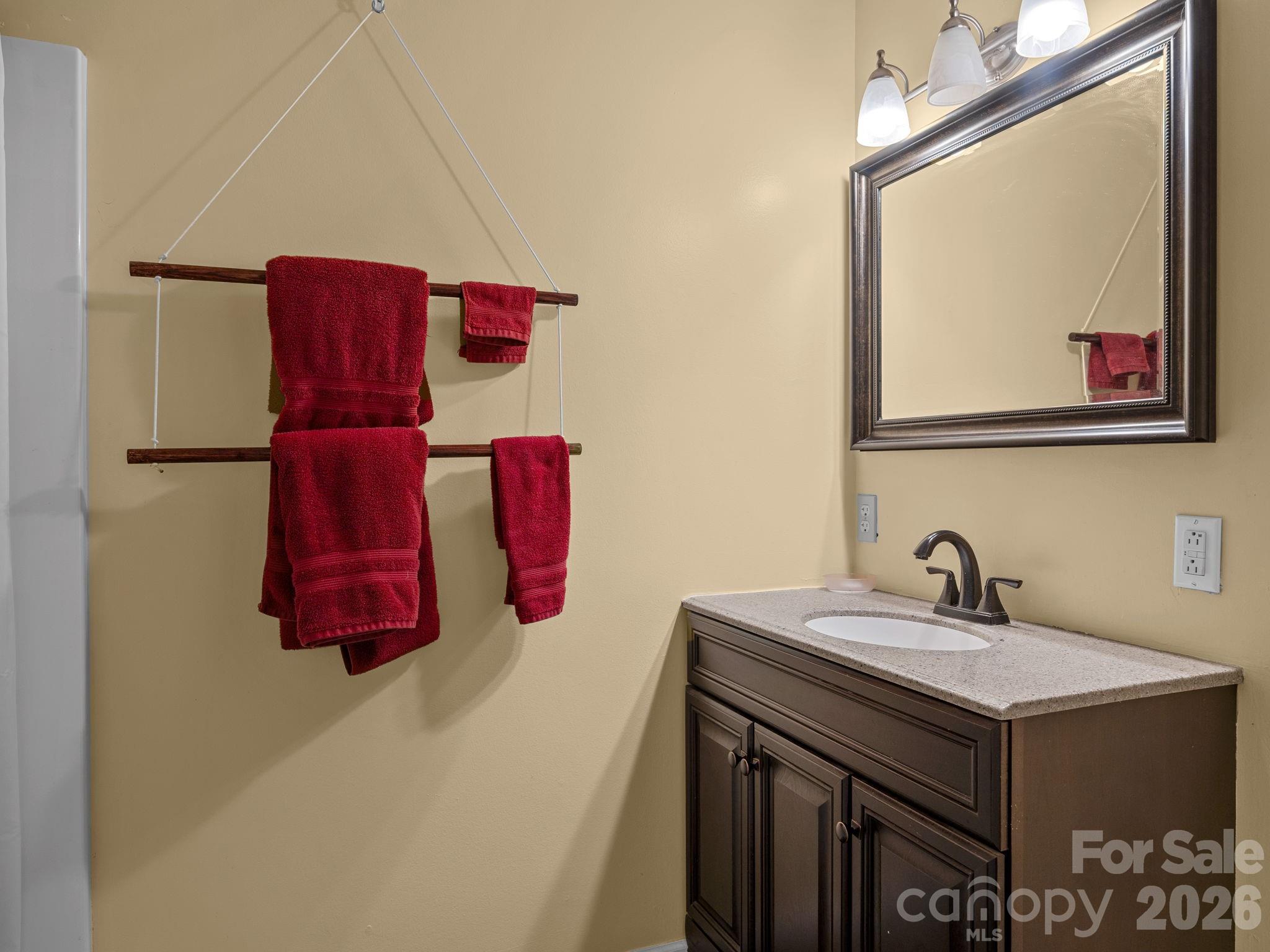 1434 Lake Adger Road Mill Spring, NC 28756 - Photo 19 of 47 a bathroom with a sink and a mirror