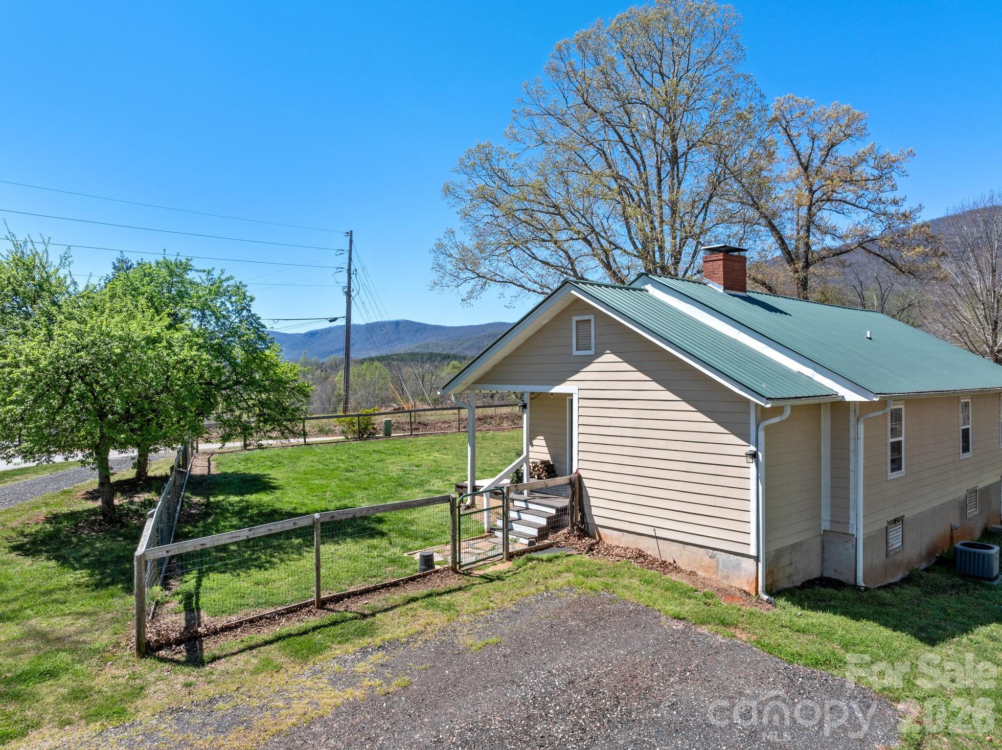 1434 Lake Adger Road Mill Spring, NC 28756 - Photo 2 of 47 a view of a house with a yard