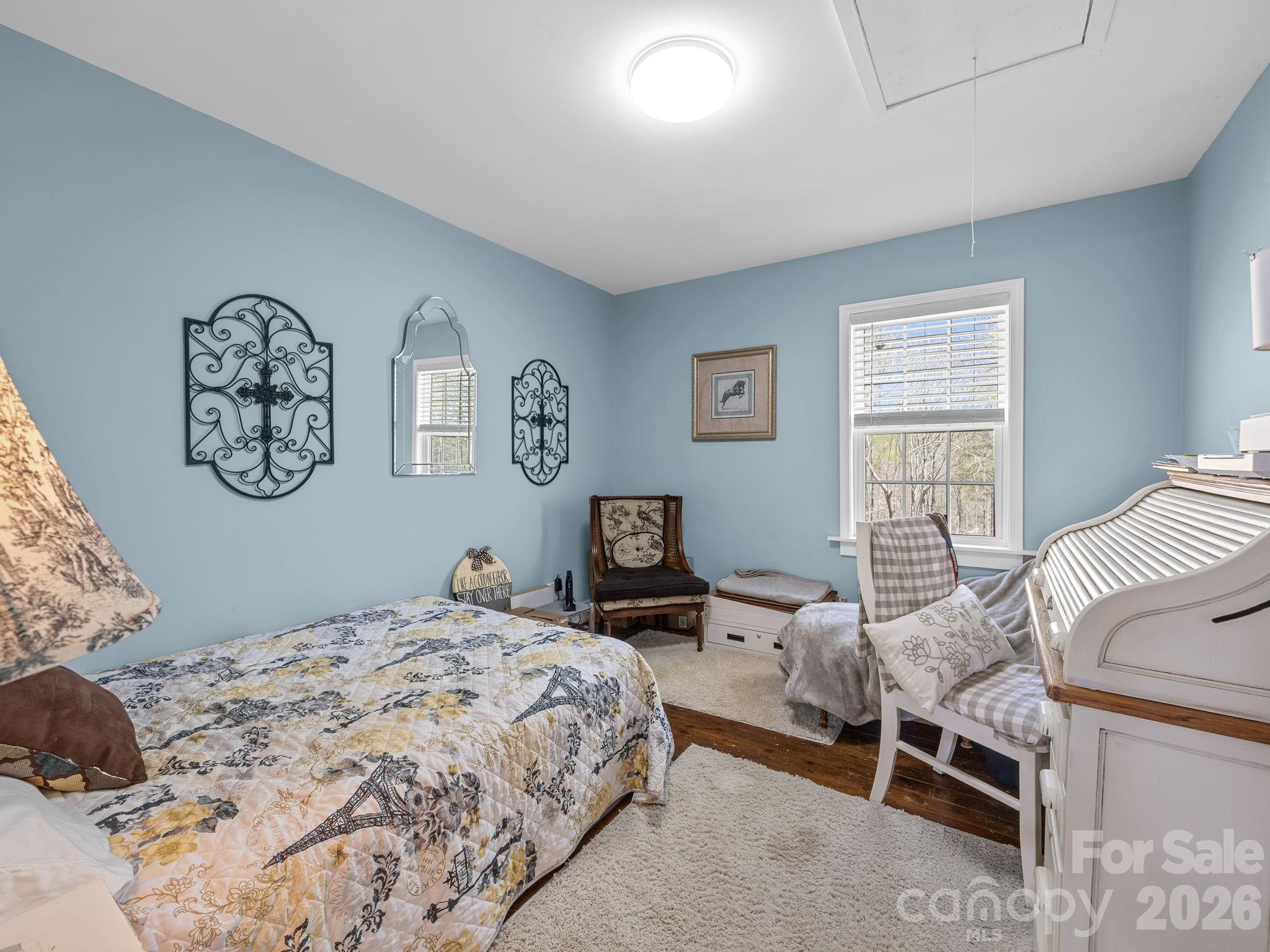 1434 Lake Adger Road Mill Spring, NC 28756 - Photo 21 of 47 a bedroom with a bed and a lamp on dresser