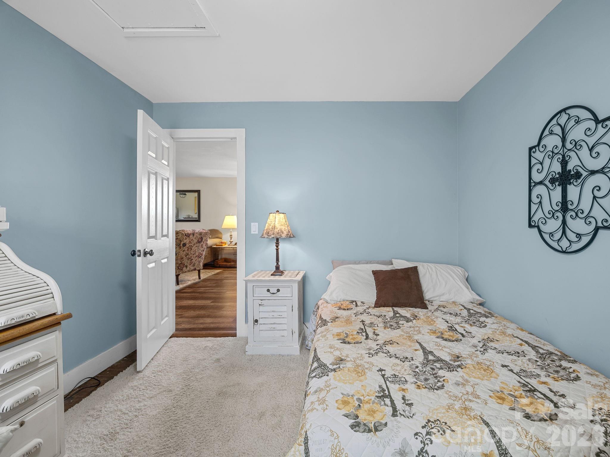 1434 Lake Adger Road Mill Spring, NC 28756 - Photo 22 of 47 a bedroom with a bed and a table in it